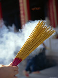 Buy Hand Holding Smoking Incense Sticks in Hong Kong, Asia at AllPosters.com