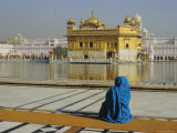 Buy A Pilgrim in Blue Sits by the Holy Pool of Nectar at the Golden Temple, Punjab, India at AllPosters.com