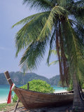 Wooden Boat Beneath Palm Trees on Beach, off the Island of Phuket, Thailand