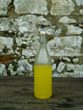Buy Bottle of Limoncello Sits on a Picnic Table at a Tuscan Villa, Tuscany, Italy at AllPosters.com