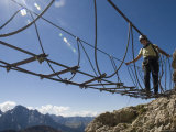 Climber Walks Across a Cable Bridge on a Via Feratta Up Piz Boe, Italy