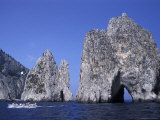 Faraglioni Rocks with a Boat in the Bay of Naples at Capri Island in Italy