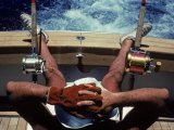 Man Takes a Break from Fishing on a Boat in the Bahamas