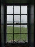 Looking Through the Window of Historic Home to a Sailboat on the Sound, Stonington, Connecticut