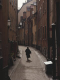 Sweden, Stockholm, Woman Walking on Narrow Streets of Gamlestaden, Rear View