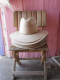 Buy Stack of Straw Hats Sitting on Wood Chair in a Doorway, California at AllPosters.com