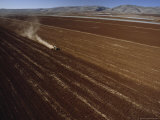 Tractor Plows a Large Field, The Judean Hills Are in Background