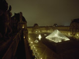 The Pyramid Glows at Night in the Cour Napoleon III at the Louvre, France