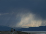 Buy Storm over the Pilot Mountains and Trucks Traveling over Salt Flats, Utah at AllPosters.com