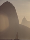 Buy Sugar Loaf Mountain Towers above a Sailboat on Guanabara Bay at AllPosters.com