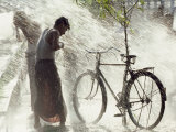 Two Men Are Hosed Down for Purification at the Water Throwing Festival in Burma