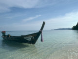 Buy Wooden Boat Named Paradise is Tethered to a Palm Tree at AllPosters.com