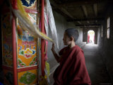 Buy Young Monk Spinning a Prayer Wheel with Flags in a Monastery, Qinghai, China at AllPosters.com