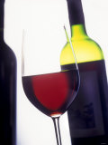 A Glass of Red Wine with a Bottle in the Background
