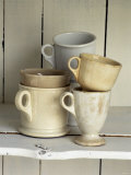 Various Light Coloured Cups on Wooden Shelf