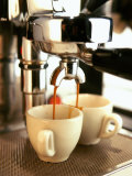 Espresso Running out of Espresso Machine into Two Cups