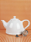 White Teapot and Tea Strainer
