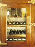 Several Wine Bottles in Wood-Panelled Drinks Cabinet