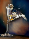 Vodka Martini Spilling from a Bent Martini Glass with Ice Cube