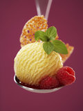 A Scoop of Vanilla Ice Cream with Hot Raspberries on a Spoon
