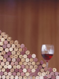 Wine Corks, Piled Up, and a Glass of Red Wine