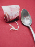 Rose Hip Tea Bag, Spoon Beside It