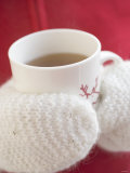 Hands in Mittens Holding Cup of Hot Tea