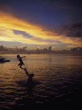 Father Playfully Throwing Son in Water