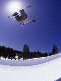 Airborne Snowboarder in Half Pipe Position