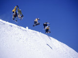 Snowboarders Jumping off Overhang, CO