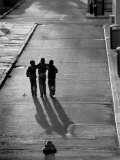 Three Boys Walking Down Street Arm in Arm