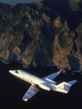 Lear Jet in Flight Over Mountains