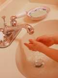Young Girl Washing Hands in Sink