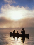 Silhouetted Father and Son Fishing from a Canoe