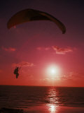 Paraglider Over the Sea and Beach at Sunset