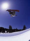Airborne Snowboarder in Half Pipe Position