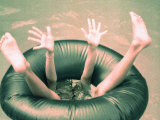Legs and Feet of a Child in Pool's Tube Photographic Print