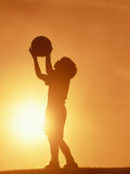 Silhouette of Boy Holding Basketball