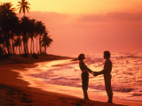 Silhouetted couple standing on a tropical beach