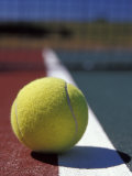 Tennis Ball Resting on the Out-of-Bounds Line