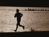 Silhouette of a Jogger Next to Water