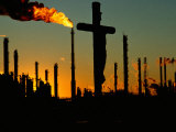 Buy A Crucifix is Silhouetted against Refinery Stacks at AllPosters.com