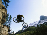 Buy Man Jumping on His Mountain Bike with Ha Ling Peak in the Background at AllPosters.com