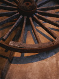 Close-up of Wooden Wagon Wheel Lit by Setting Sun