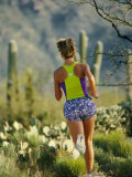 Buy A Woman Runs Through the Desert Landscape at AllPosters.com