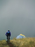 Buy A Woman Rides Her Bicycle Towards a Tent in the Background at AllPosters.com