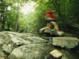 Panned View of Man Leaping over Rocky Stream on the Appalachian Trail