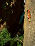 A Rock Climber Scales the Vertical Face of a Mountain