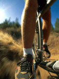 A Close View Photo of a Mountain Bikers Pedals as He Whizzes by on the Dirt Trail