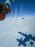 Prop Plane Casts a Shadow on the Ice Below